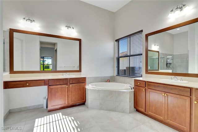 bathroom with tile patterned flooring, vanity, and separate shower and tub