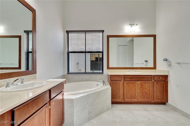 bathroom with vanity, tile patterned flooring, and a relaxing tiled tub