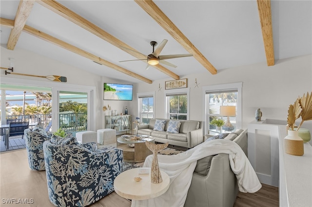 living room with lofted ceiling with beams, hardwood / wood-style floors, and a healthy amount of sunlight