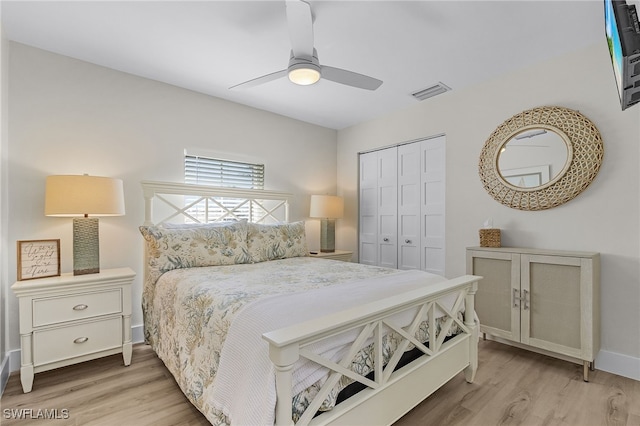 bedroom with ceiling fan, light hardwood / wood-style flooring, and a closet