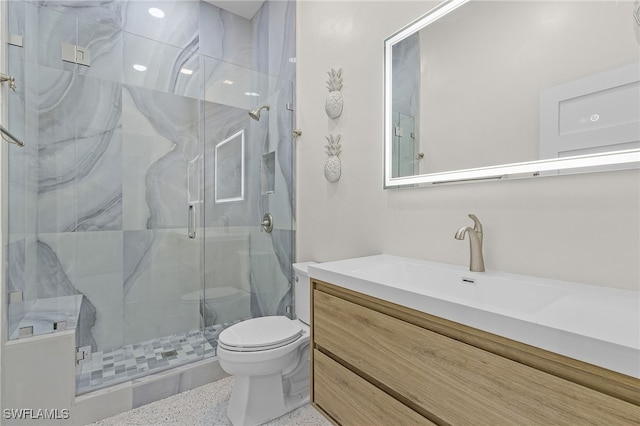 bathroom featuring walk in shower, vanity, and toilet