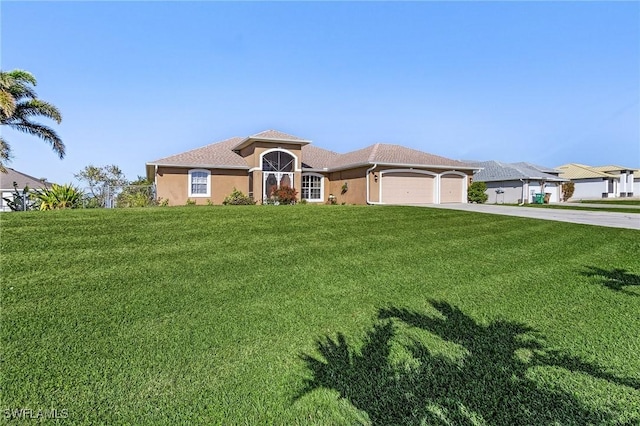 view of front of home featuring a garage and a front lawn