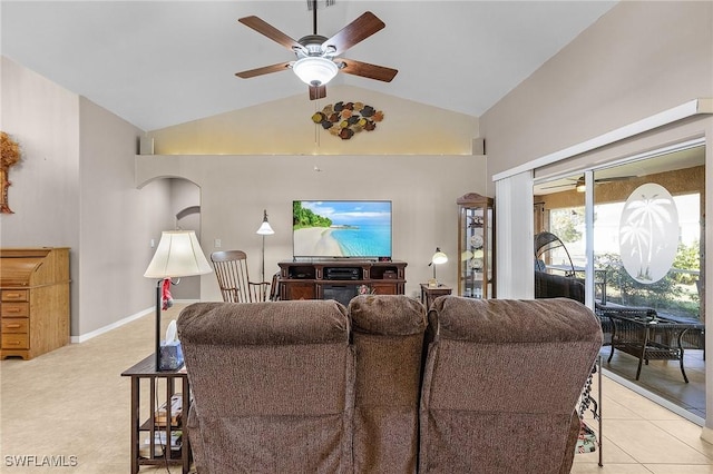 living room featuring ceiling fan, light tile patterned floors, and lofted ceiling