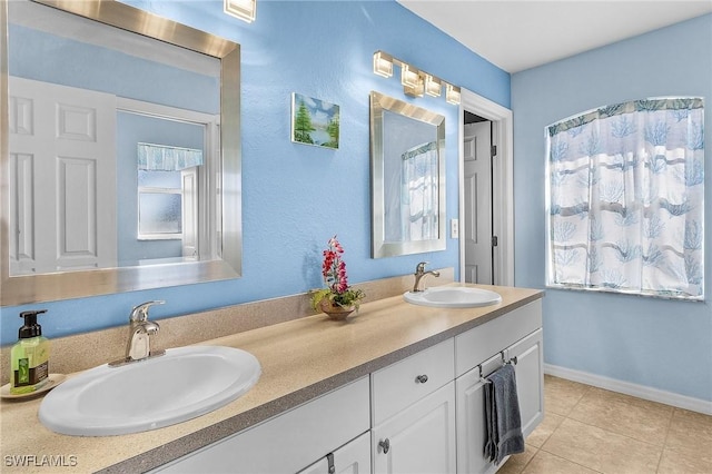 bathroom featuring tile patterned flooring and vanity