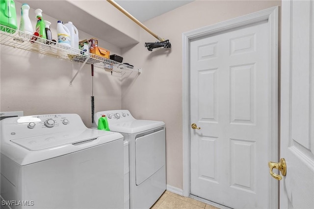 clothes washing area featuring separate washer and dryer and light tile patterned flooring