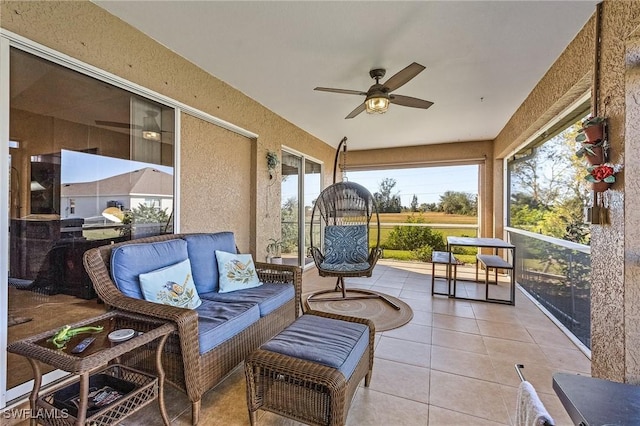 sunroom featuring ceiling fan