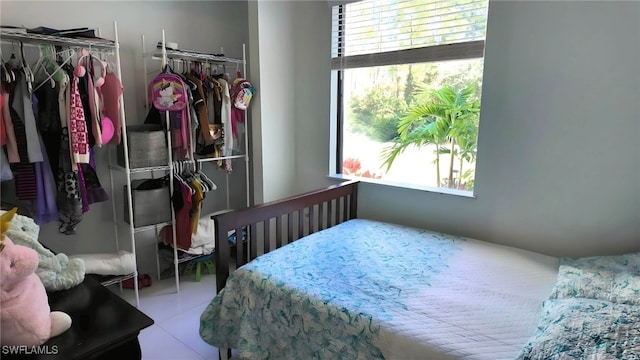 bedroom with a closet and light tile patterned flooring