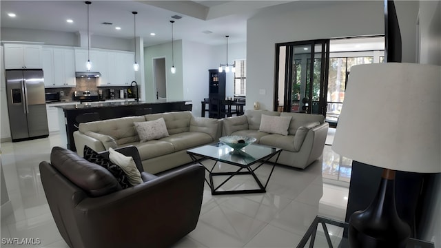 tiled living room with a chandelier