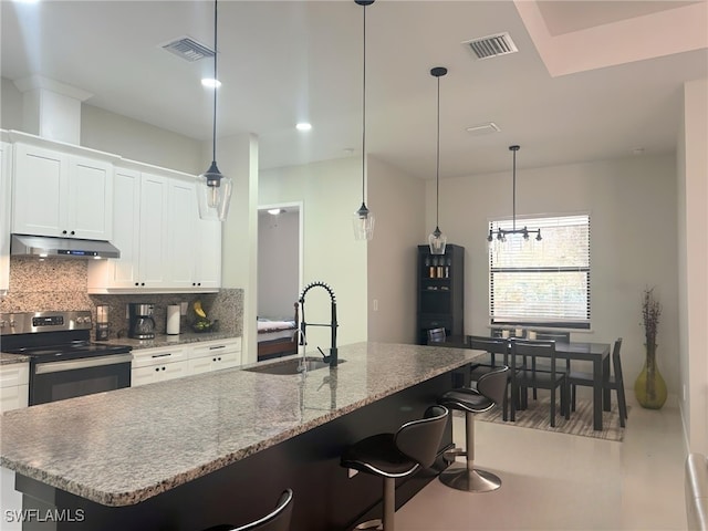 kitchen with stainless steel electric stove, white cabinetry, sink, and a kitchen island with sink