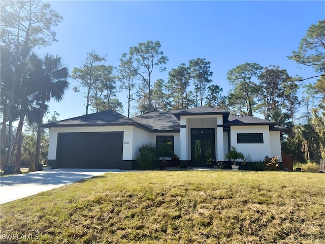 view of front of property with a front yard and a garage