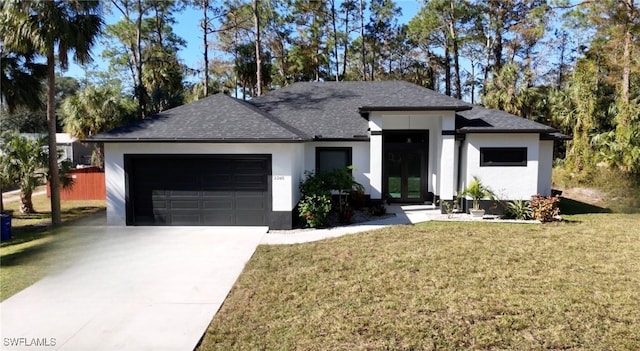 view of front of house with a garage and a front yard