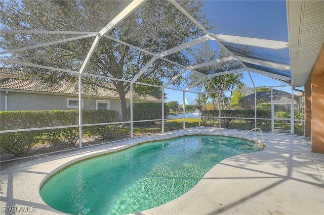 view of swimming pool featuring a patio and glass enclosure