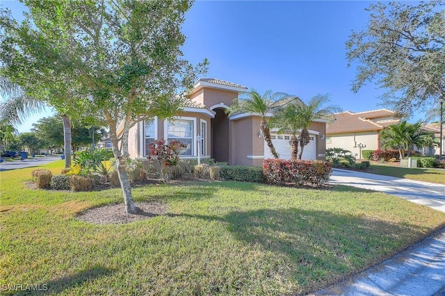 mediterranean / spanish-style house with a front yard and a garage