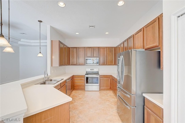 kitchen featuring kitchen peninsula, decorative light fixtures, stainless steel appliances, and sink