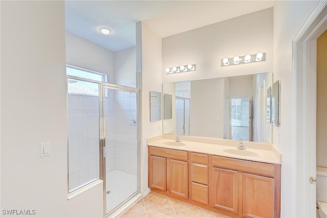 bathroom with tile patterned flooring, vanity, and an enclosed shower