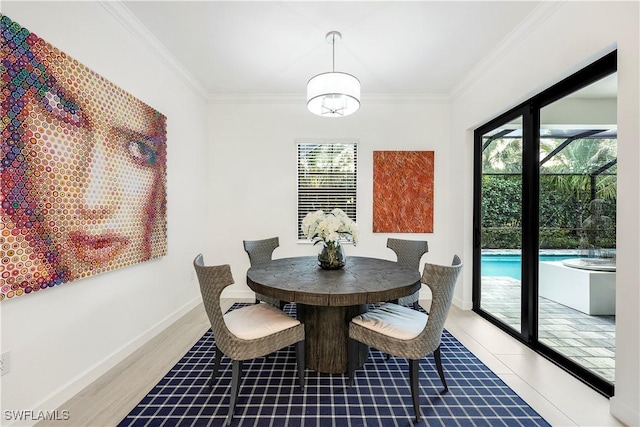 dining room featuring hardwood / wood-style floors and ornamental molding