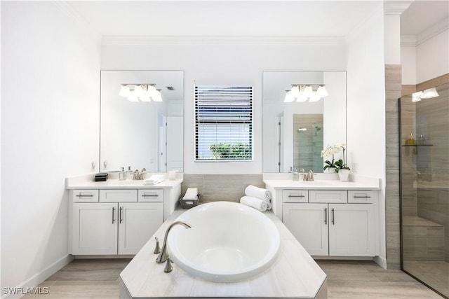 bathroom featuring hardwood / wood-style floors, vanity, independent shower and bath, and ornamental molding