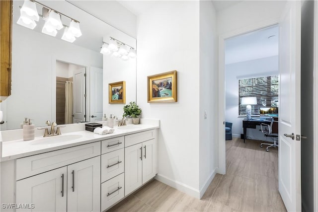 bathroom with vanity and hardwood / wood-style flooring