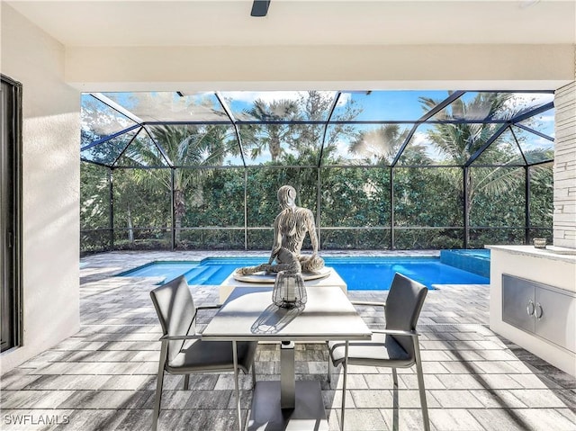 view of swimming pool featuring a patio, area for grilling, and a lanai