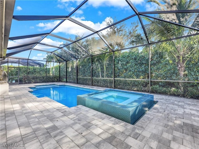 view of pool featuring a lanai, a patio, and an in ground hot tub