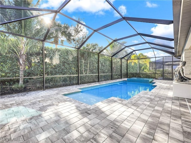 view of pool with a patio area and a lanai