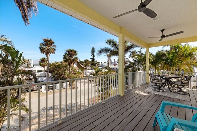 wooden terrace featuring ceiling fan