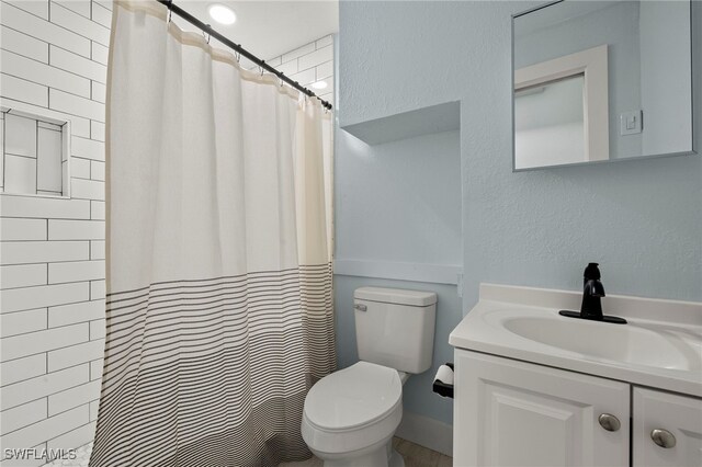 241 Pearl St, Fort Myers Beach, FL 33931 - bathroom with a shower with curtain, toilet, vanity, and a textured wall