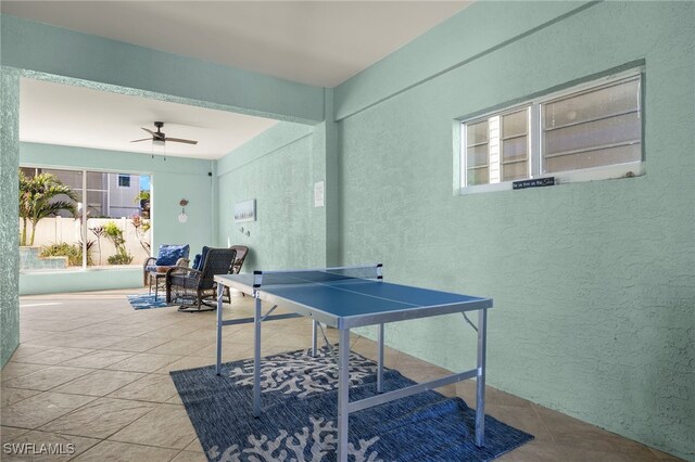 rec room with ceiling fan and light tile patterned floors