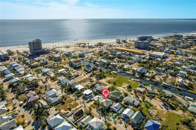 birds eye view of property with a view of the beach and a water view