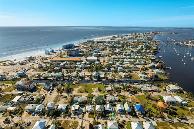 birds eye view of property with a water view and a view of the beach