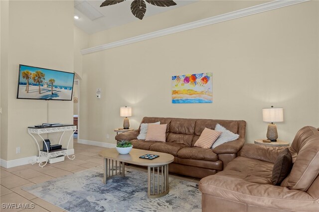 tiled living room with ceiling fan and ornamental molding