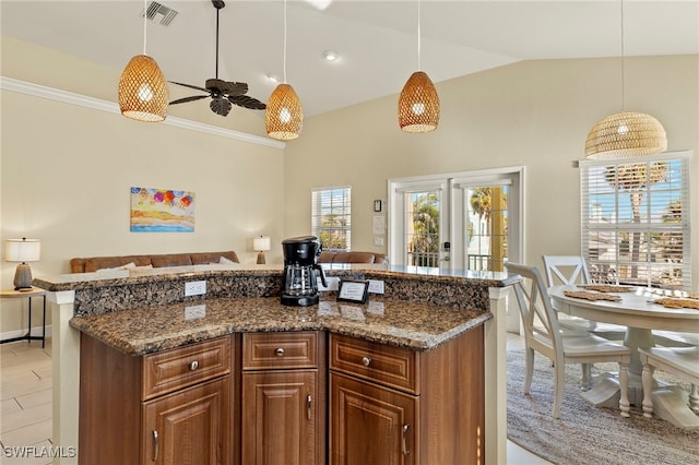 241 Pearl St, Fort Myers Beach, FL 33931 - kitchen with hanging light fixtures, visible vents, dark stone countertops, and open floor plan