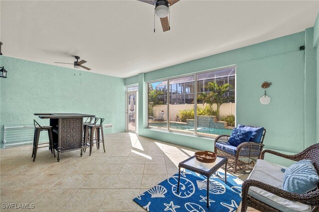 sunroom / solarium with ceiling fan