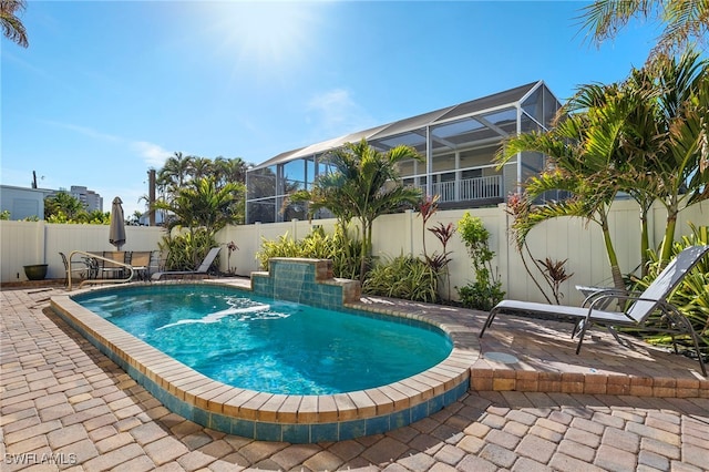241 Pearl St, Fort Myers Beach, FL 33931 - view of pool with glass enclosure, a fenced in pool, a fenced backyard, and a patio area