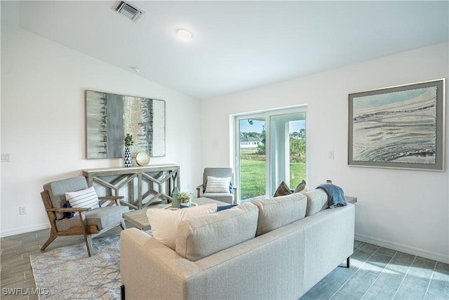 living room featuring hardwood / wood-style flooring and vaulted ceiling