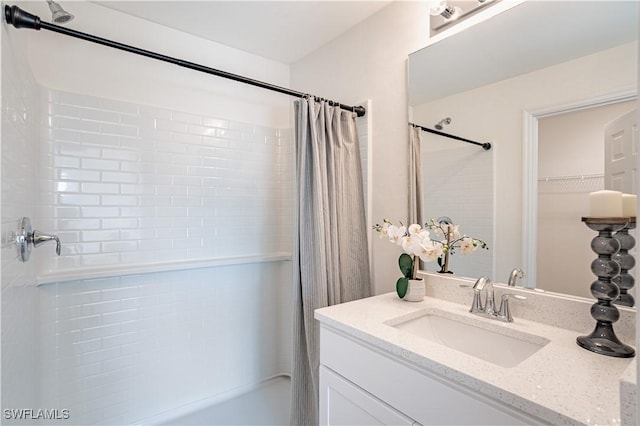 bathroom featuring vanity and shower / bath combination with curtain