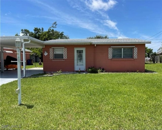 ranch-style home with a front lawn and a carport