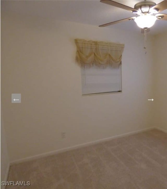 unfurnished room featuring ceiling fan and carpet