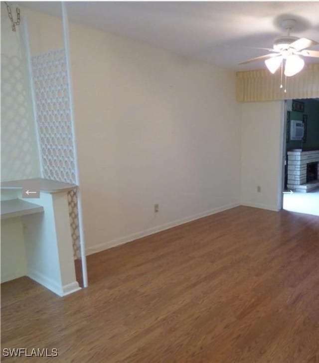 unfurnished living room featuring hardwood / wood-style flooring and ceiling fan