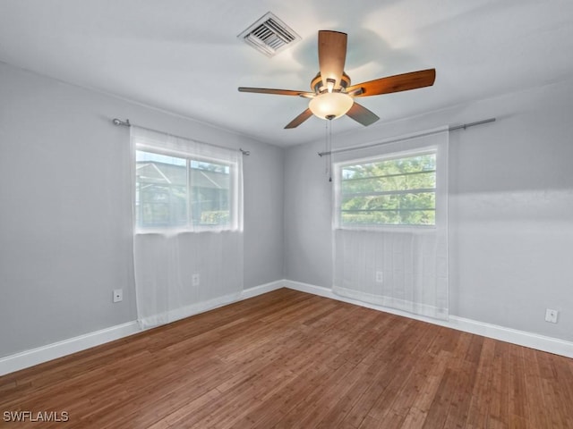 spare room with hardwood / wood-style flooring and ceiling fan