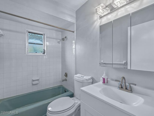 full bathroom featuring tiled shower / bath combo, toilet, and vanity