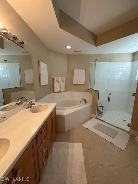 bathroom with plus walk in shower, vanity, and tile patterned floors