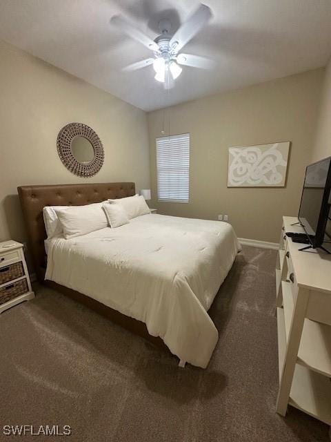 bedroom with ceiling fan and dark carpet