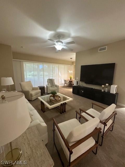 carpeted living room featuring ceiling fan