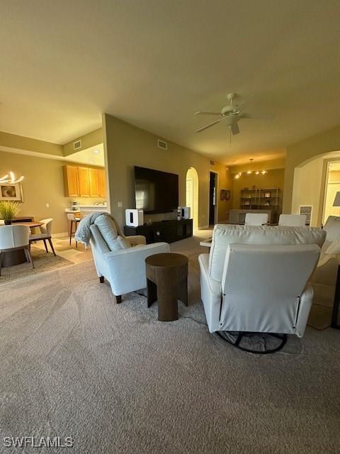 carpeted living room featuring ceiling fan