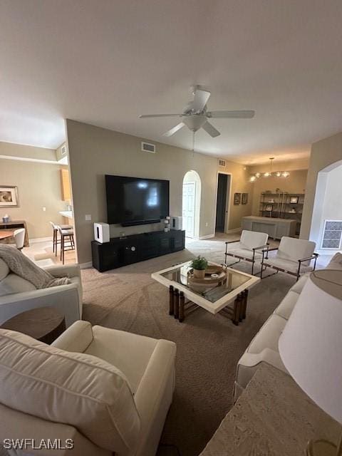 living room with ceiling fan and light colored carpet