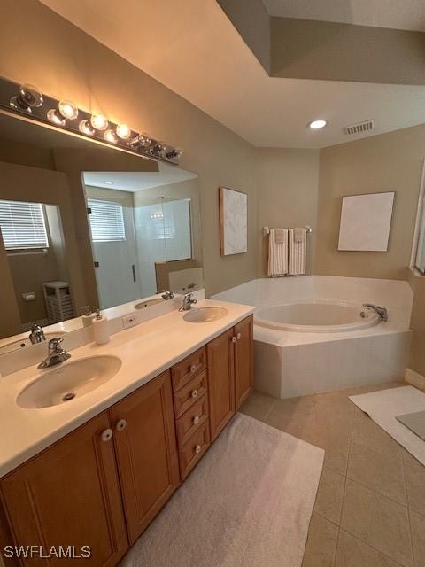 bathroom featuring tile patterned floors, vanity, and plus walk in shower