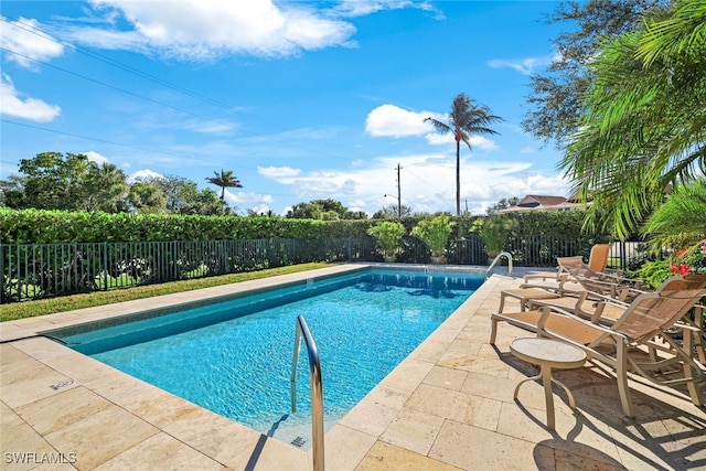 view of swimming pool featuring a patio area