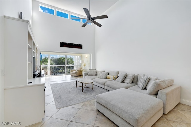 tiled living room with ceiling fan and a towering ceiling