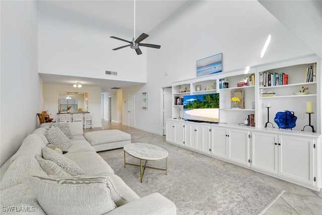 living room featuring ceiling fan, high vaulted ceiling, and light tile patterned floors